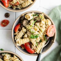 Top down view of pesto pasta salad in bowls.