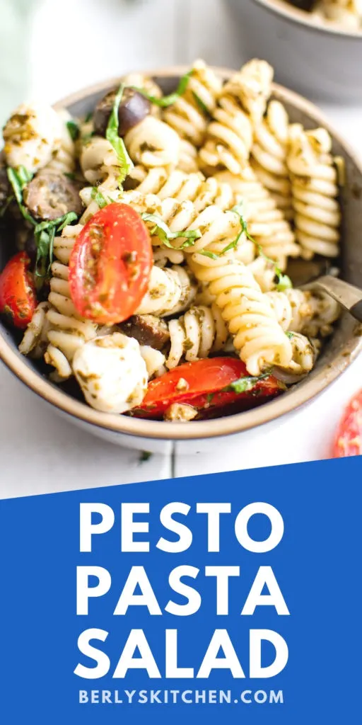 Large bowl filled with pesto pasta salad.