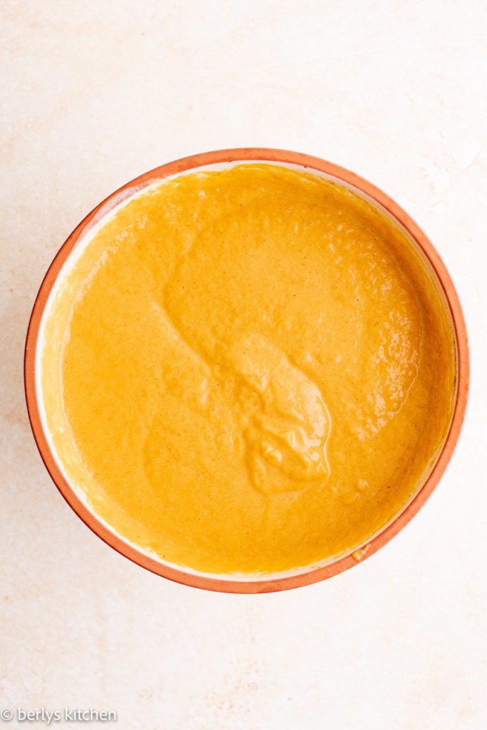 Top down view of pumpkin mixture in a bowl.