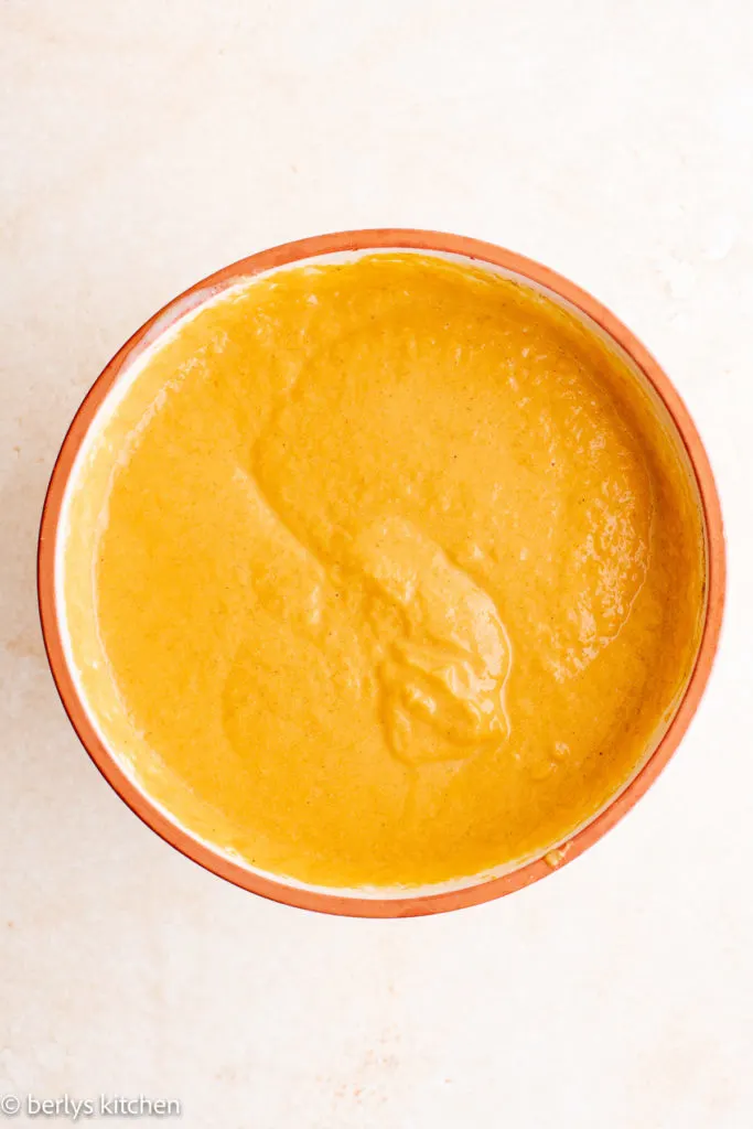 Top down view of pumpkin mixture in a bowl.