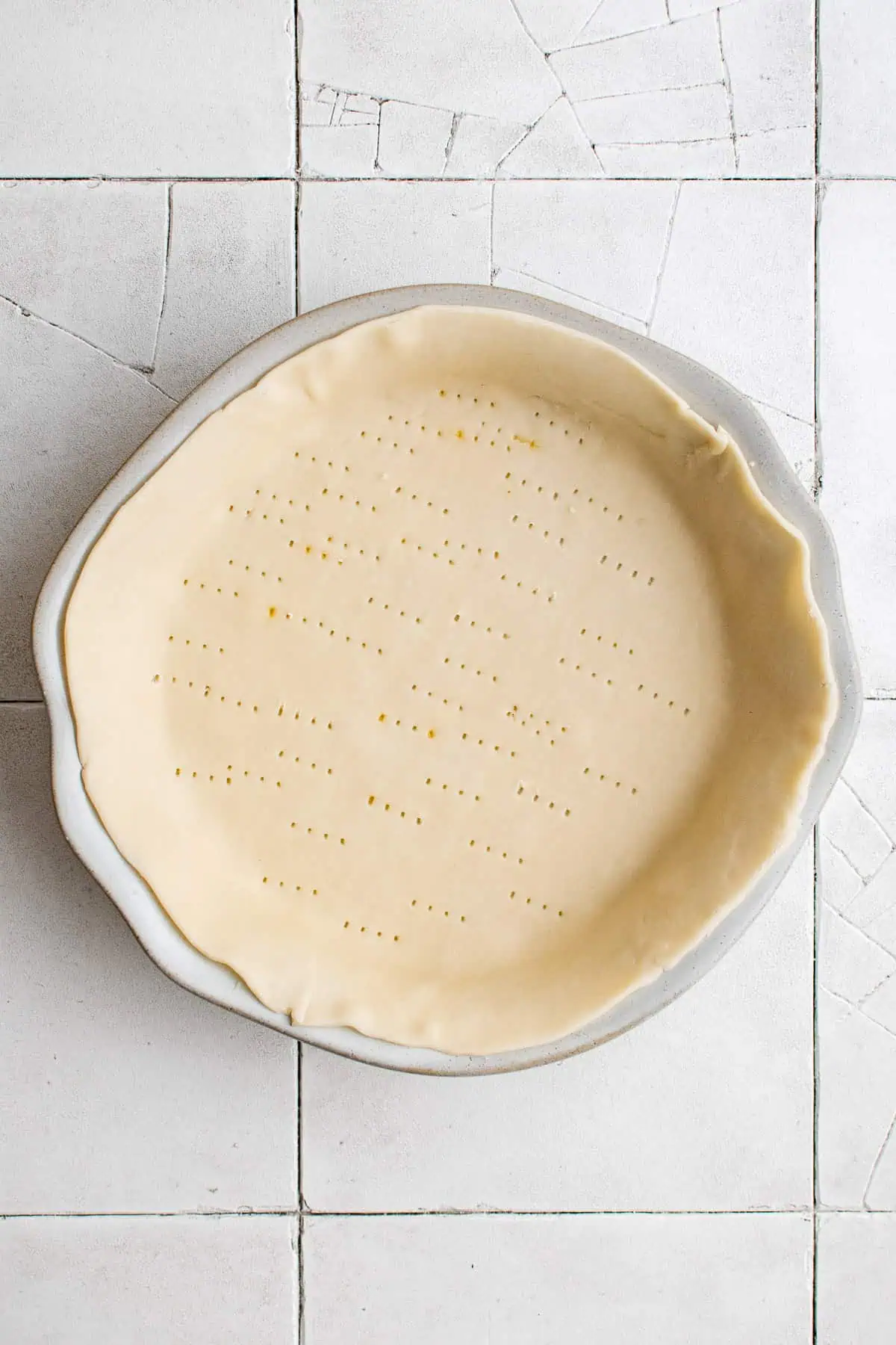 Top down view of pie crust in a baking pan.