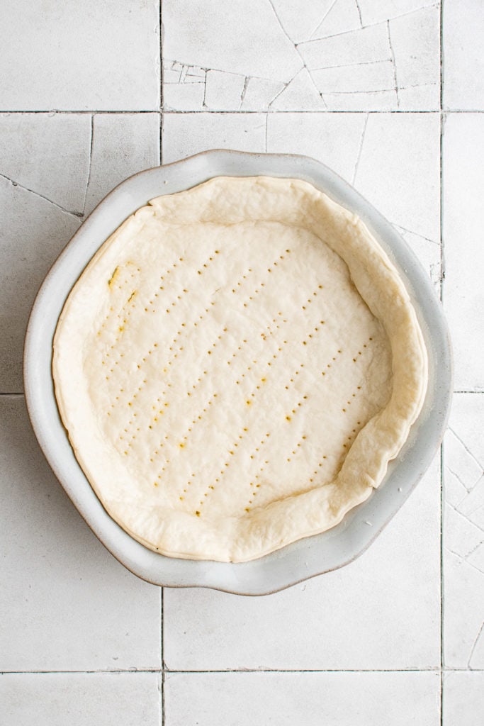Top down view of pie crust in a baking dish.