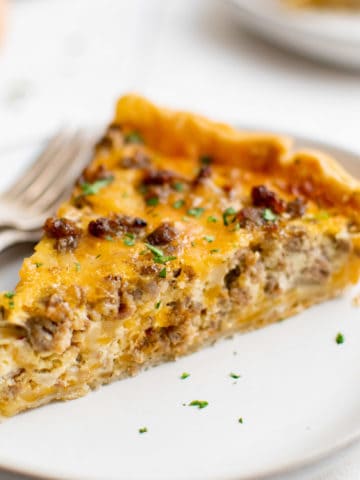 Slice of sausage quiche on plates.