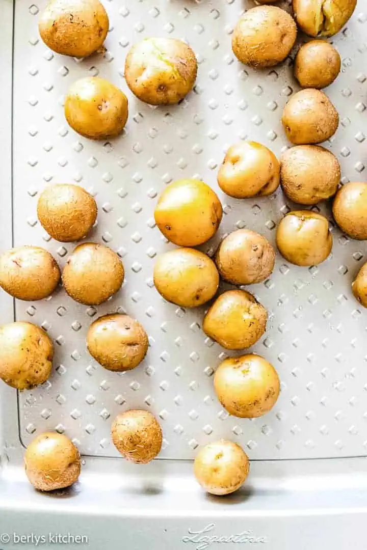 Top down view of baby potatoes on sheet pan.