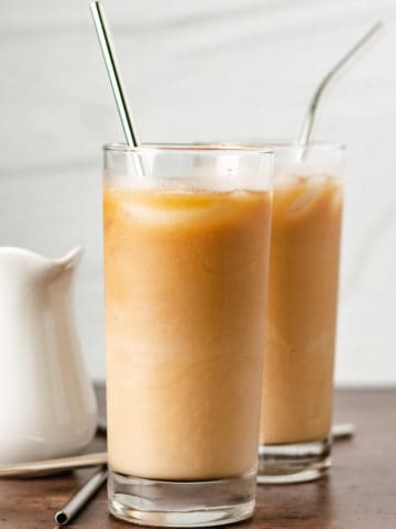 Two highball glasses filled with caramel coffee.