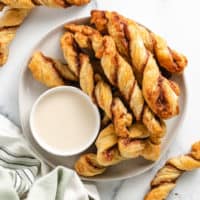 Top down view of cinnamon puff pastry with vanilla frosting.
