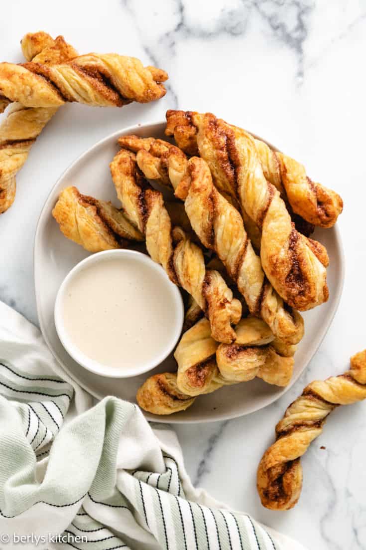 Top down view of cinnamon puff pastry with vanilla frosting.