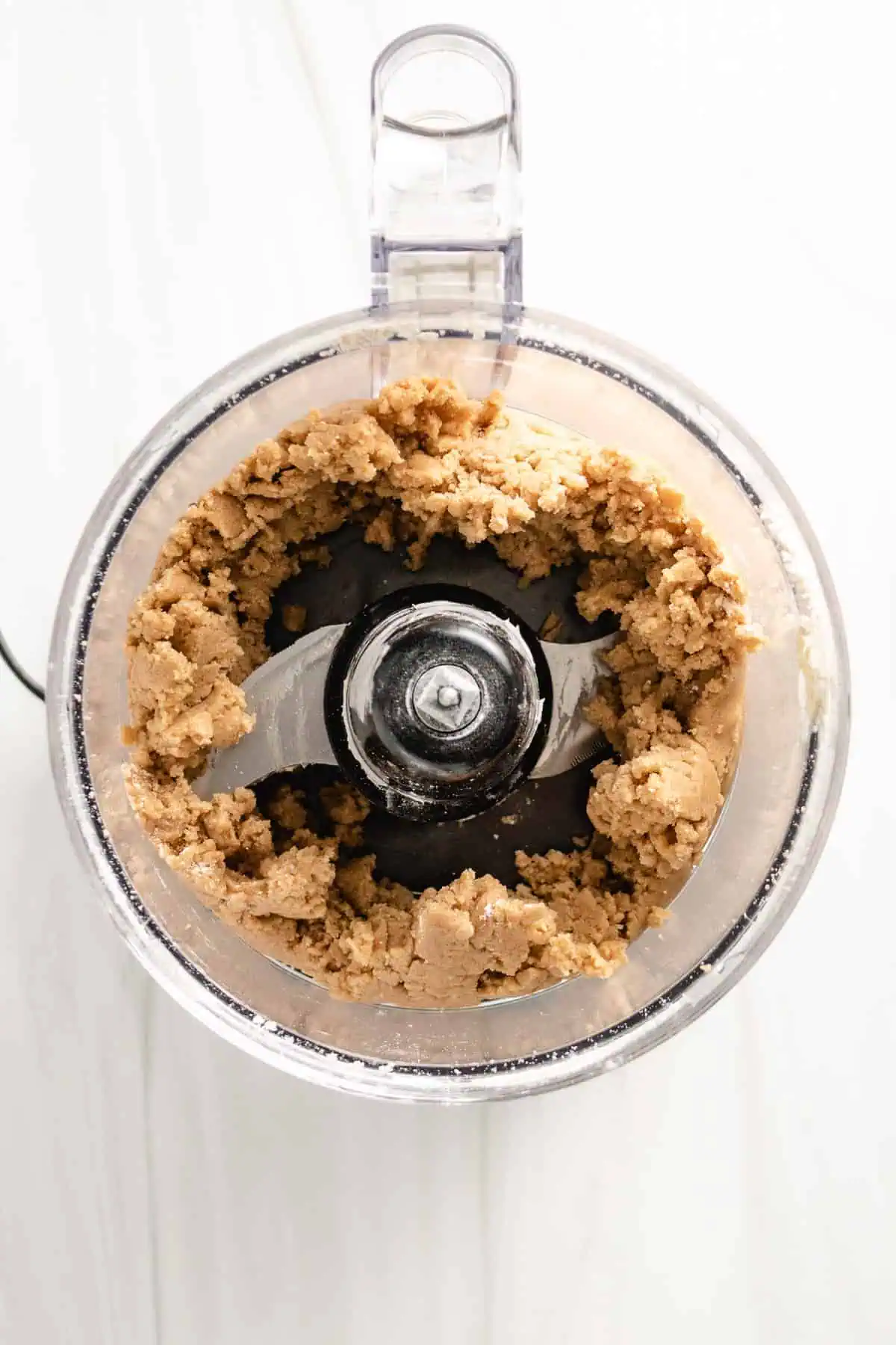 Top down view of crumble topping in a food processor.