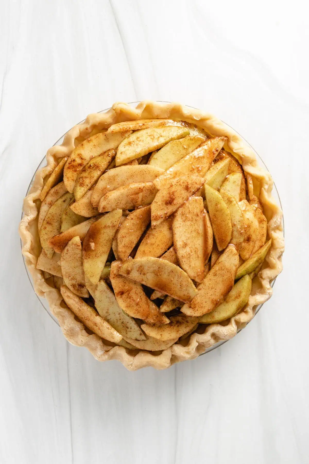 Apple filling in unbaked pie crust.