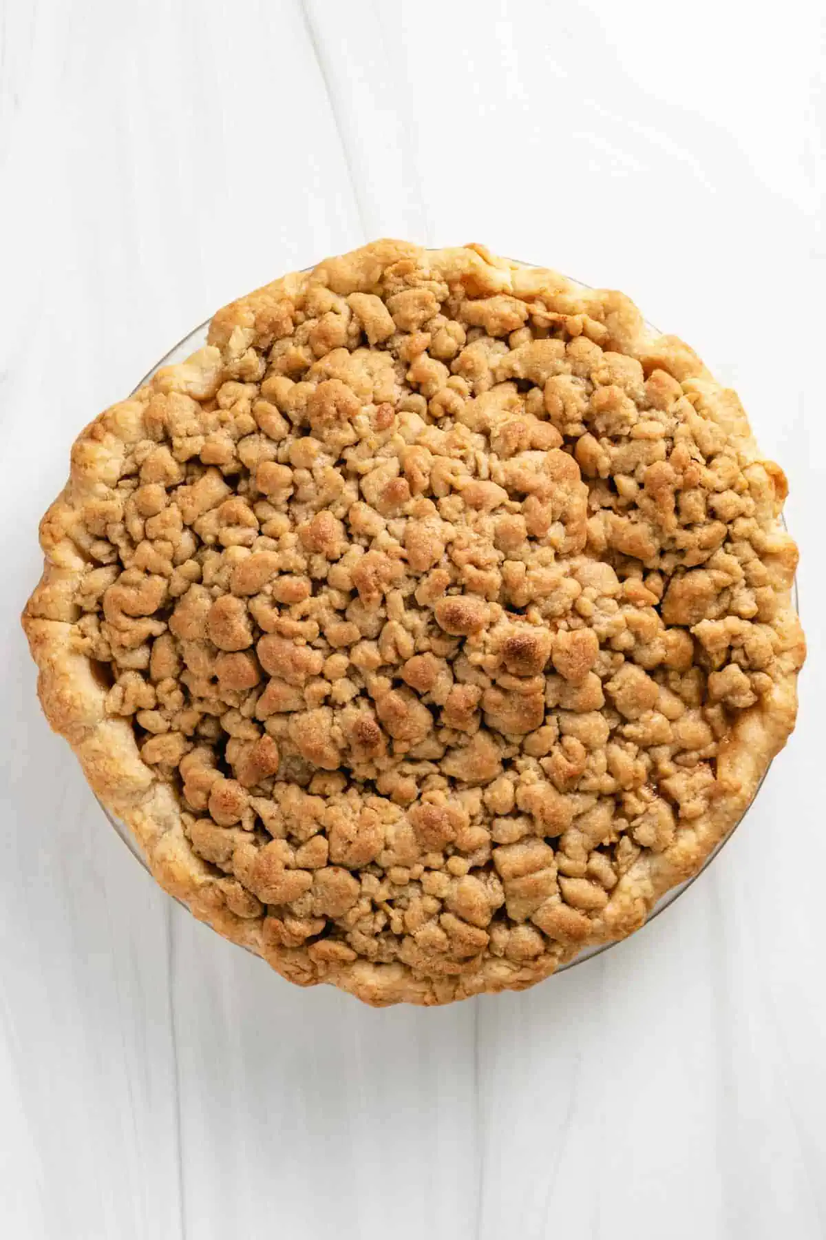 Top down view of apple pie with crumb topping.