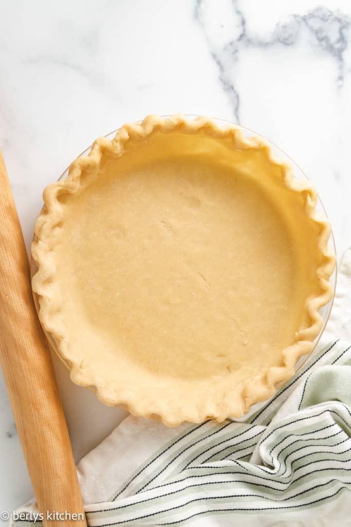 Top down view of unbaked pie shell in a dish.