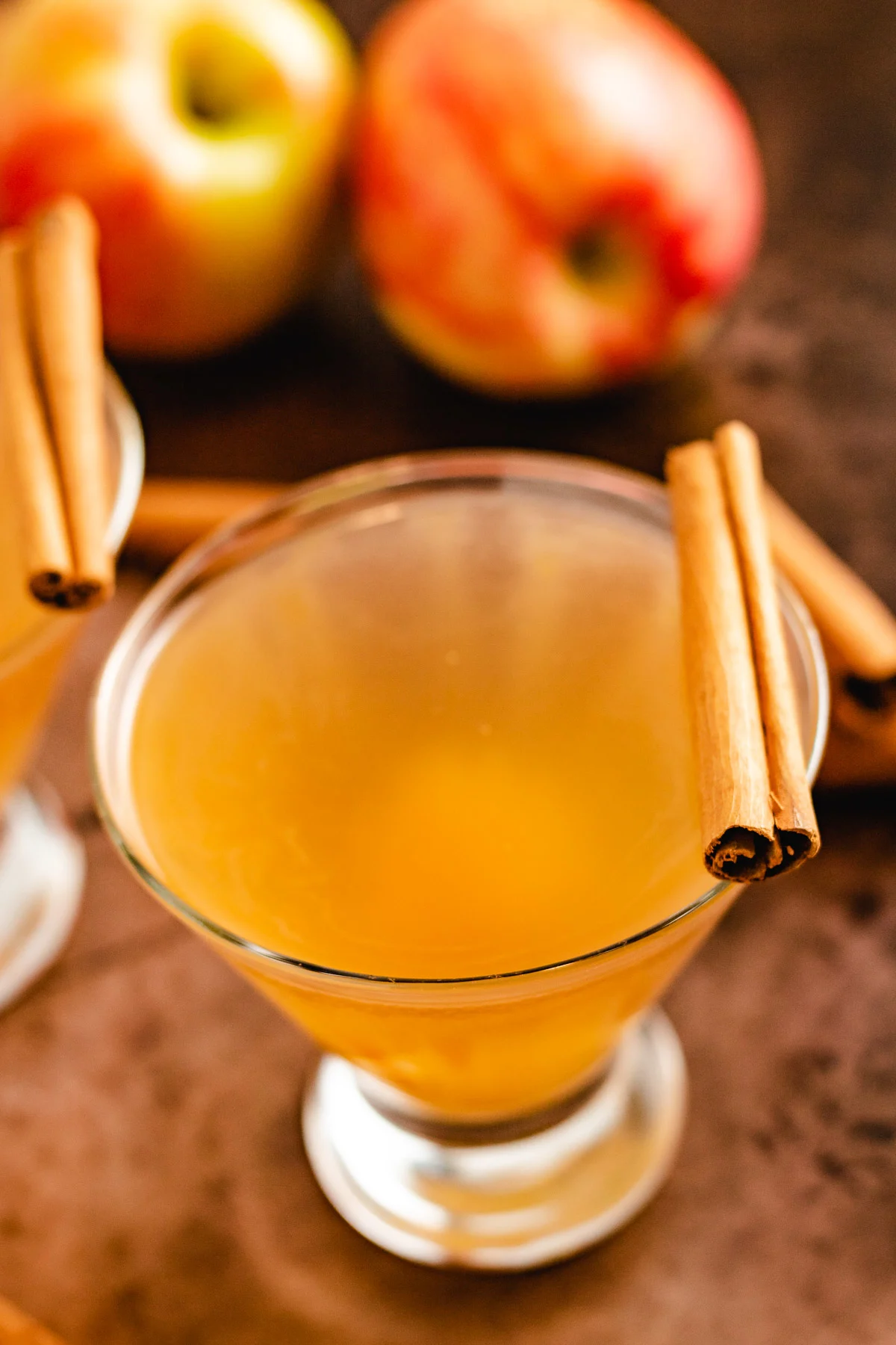 Apple cider martini with cinnamon sticks.