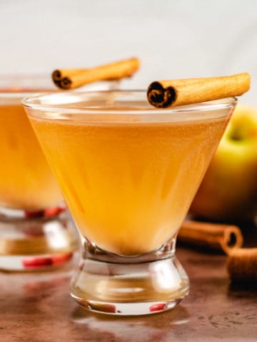 Two apple martinis with fresh apples.