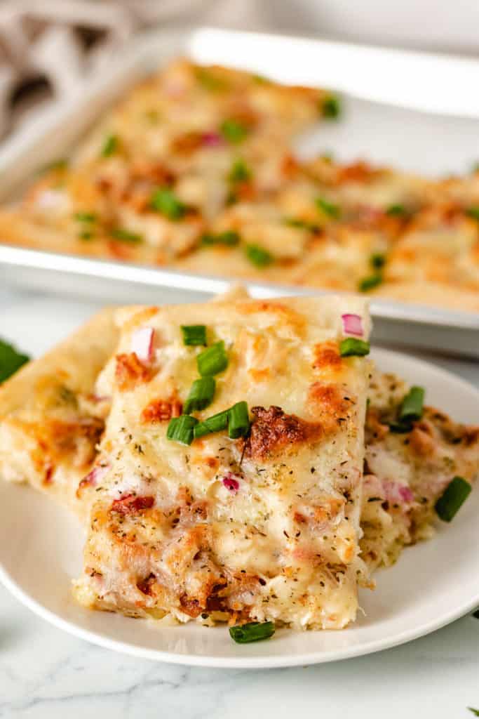 Slices of chicken pizza on a plate.