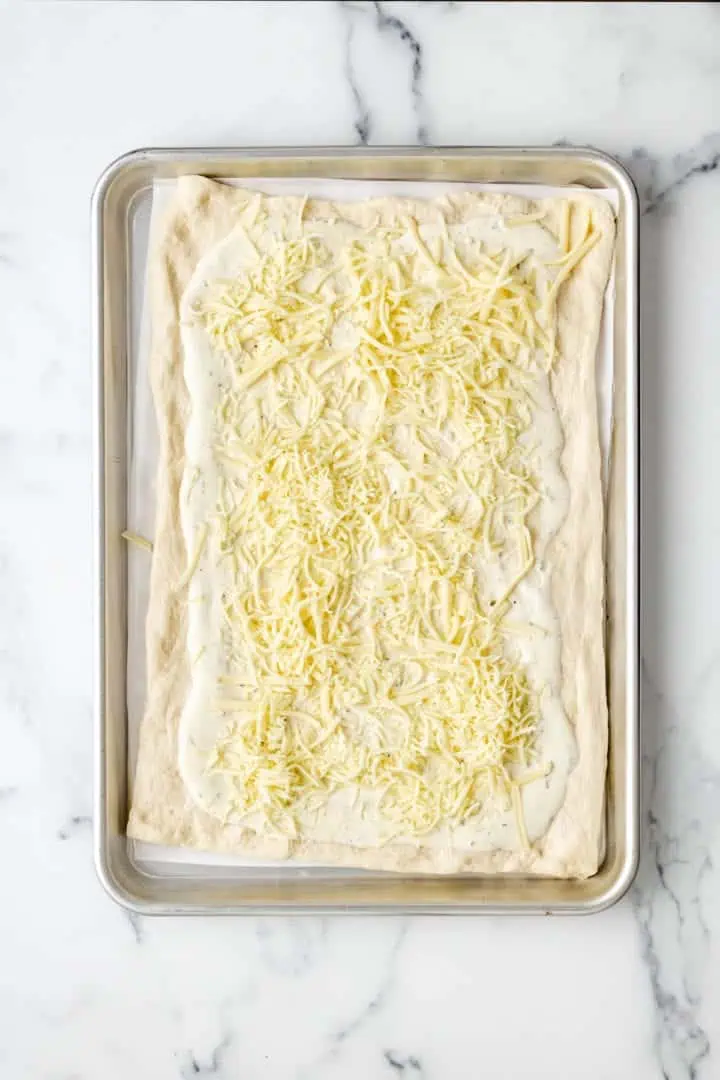 Top down view of shredded cheese on a baking dish.