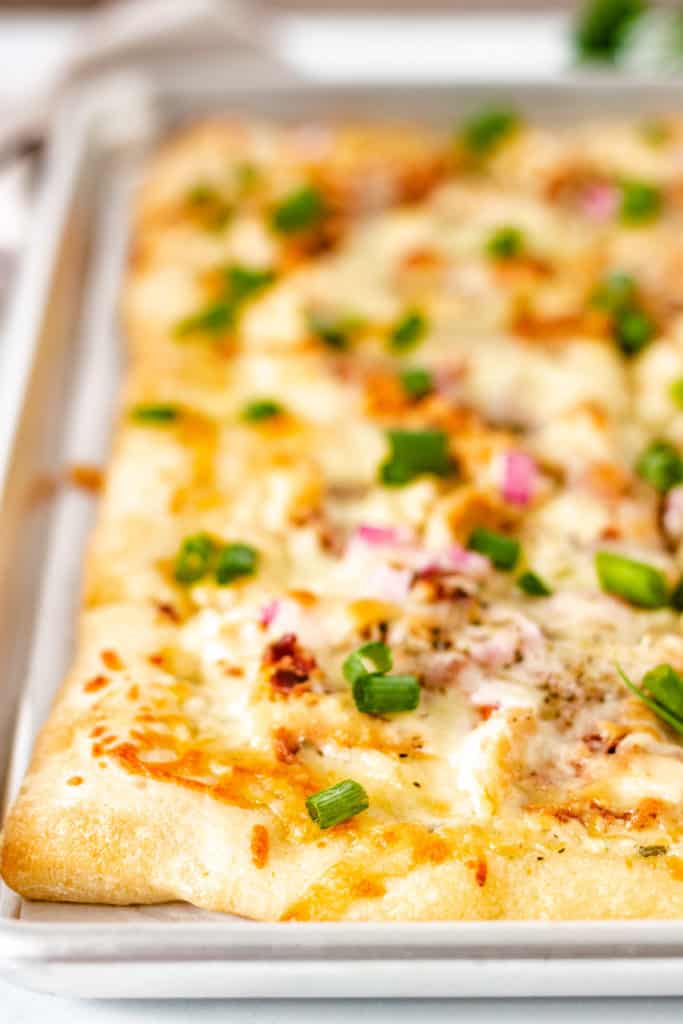 Chicken bacon pizza on a sheet pan.
