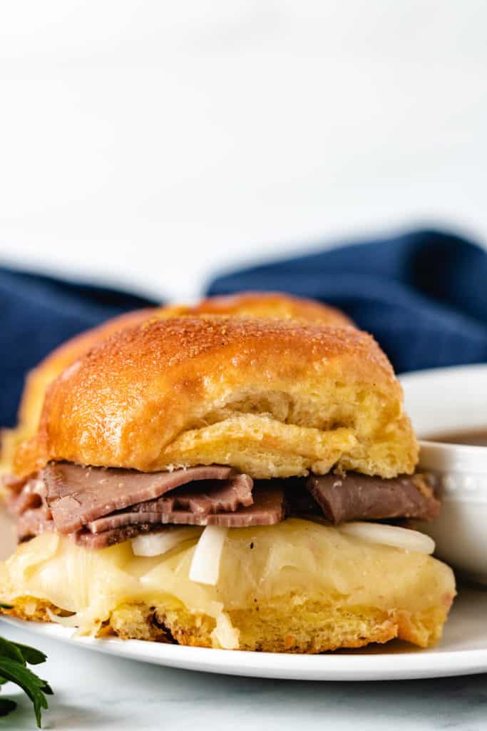 Close up of a french dip slider and au jus sauce.