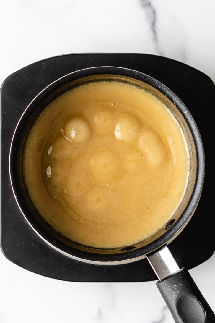 Top down view of mustard sauce in a pan.