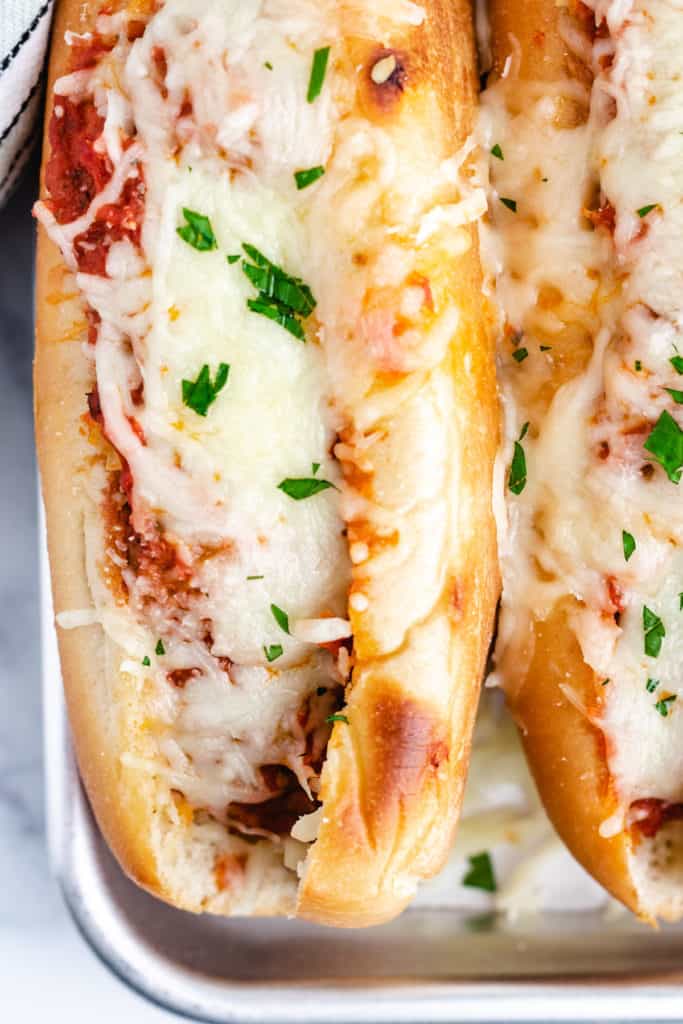 Top down view of cheesy meatball subs.