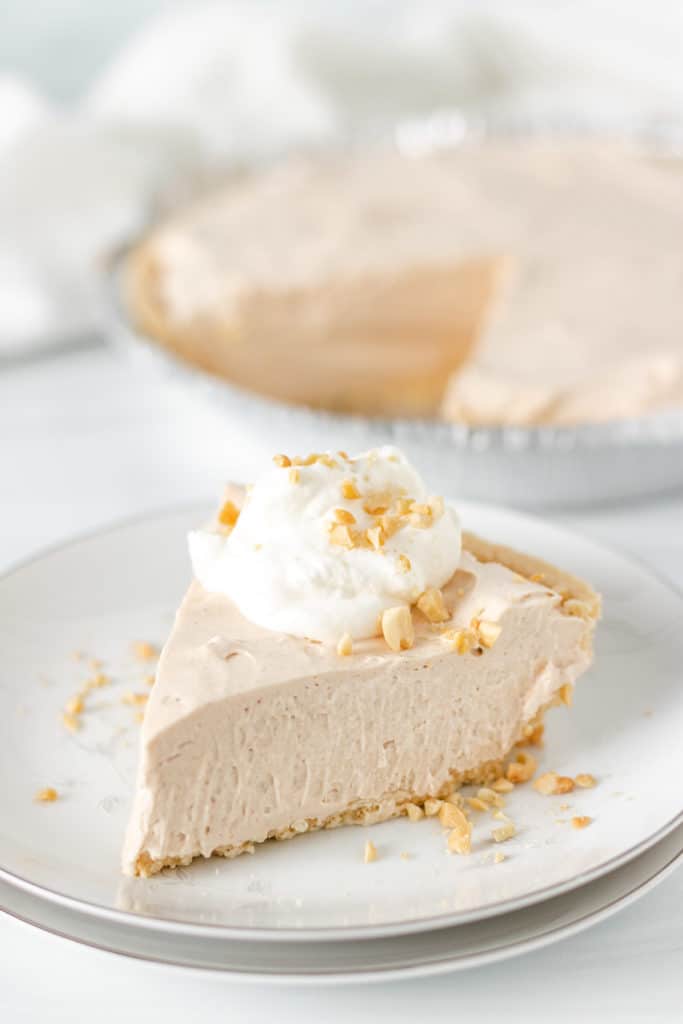 Piece of peanut butter pie with whipped cream.