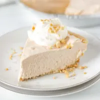Slice of peanut butter pie with crushed peanuts.