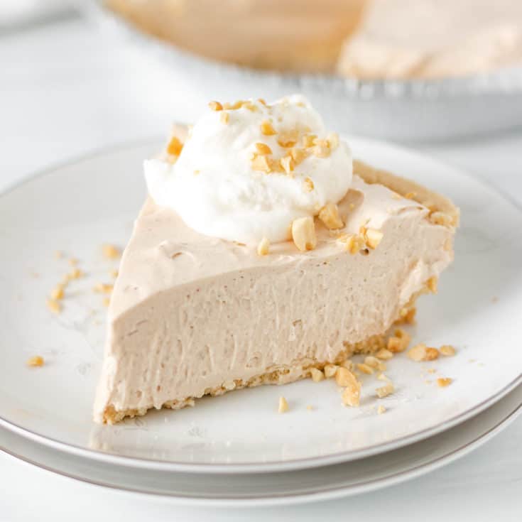 Slice of peanut butter pie with crushed peanuts.