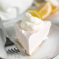 Slice of lemonade pie on a white dish.