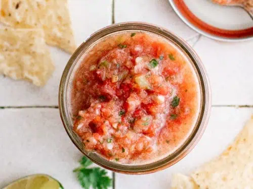 Top down view of salsa in a jar.