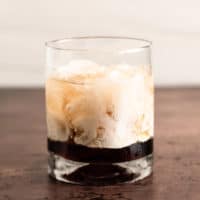 White Russian poured in a cocktail glass over ice.