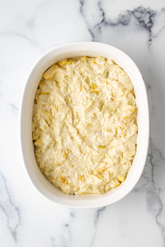 Top down view of squash casserole in a baking dish.