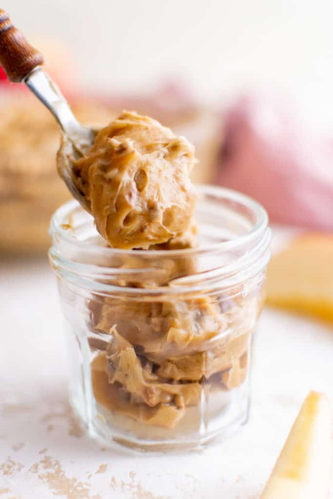 Apple dip on a metal spoon.