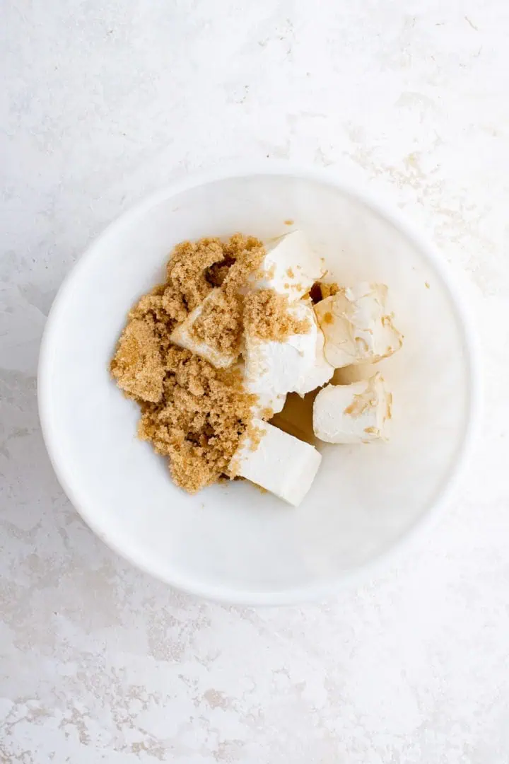 Top down view of cream cheese and brown sugar in a bowl.