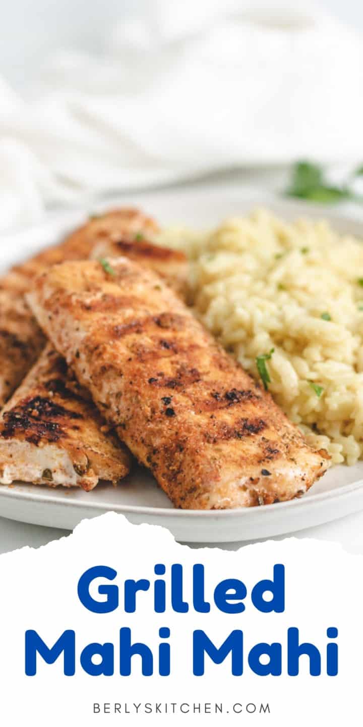 Grilled mahi mahi fillets on a plate with rice pilaf.