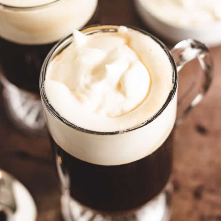 Irish Coffee Top down view of dark coffee topped with whipped cream.
