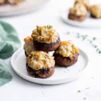 Mushrooms on a plate next to a green towel.