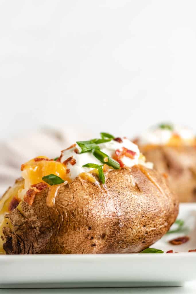 Loaded baked potato with cheese and sour cream.