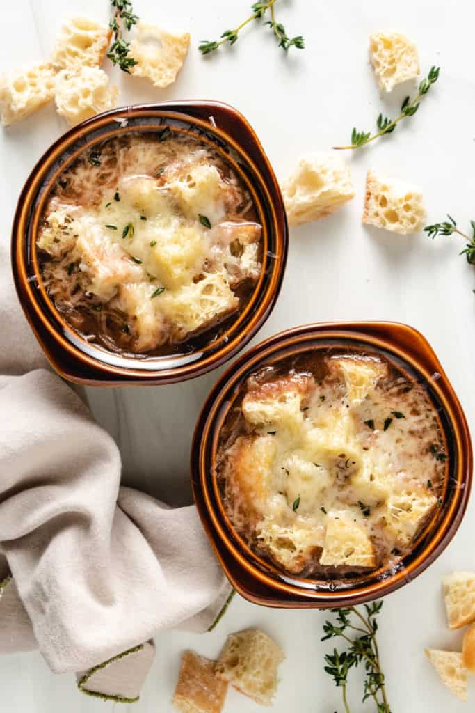 Top down view of two bowls of french onion soup.