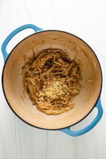 Top down view of caramelized onions in a pan.