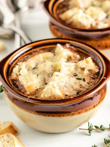 French onion soup in brown bowls.