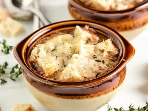French onion soup in brown bowls.