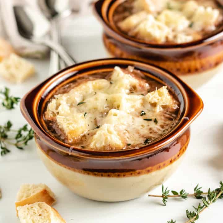 French onion soup in brown bowls.