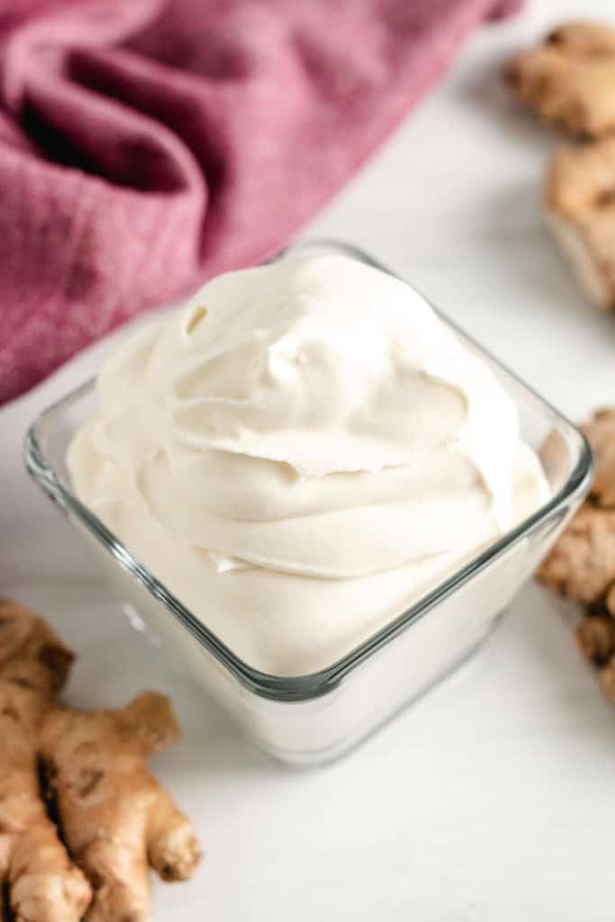 Top down view of ginger whipped cream in a bowl.