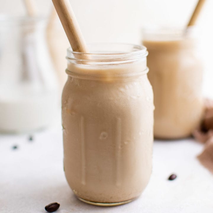 Iced Brown Sugar Oat Milk Shaken Espresso Mason jars filled with iced shaken espresso with straws.