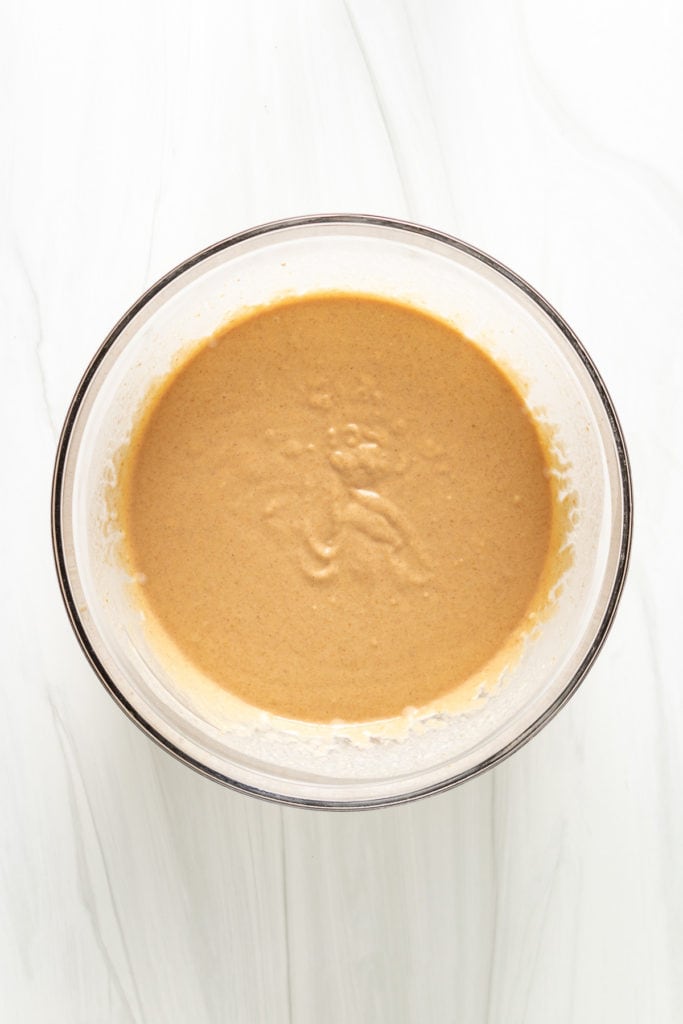 Top down view of pumpkin pancake batter in a bowl.