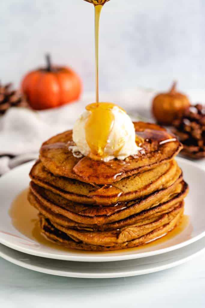 Stack of pancakes with butter and syrup.