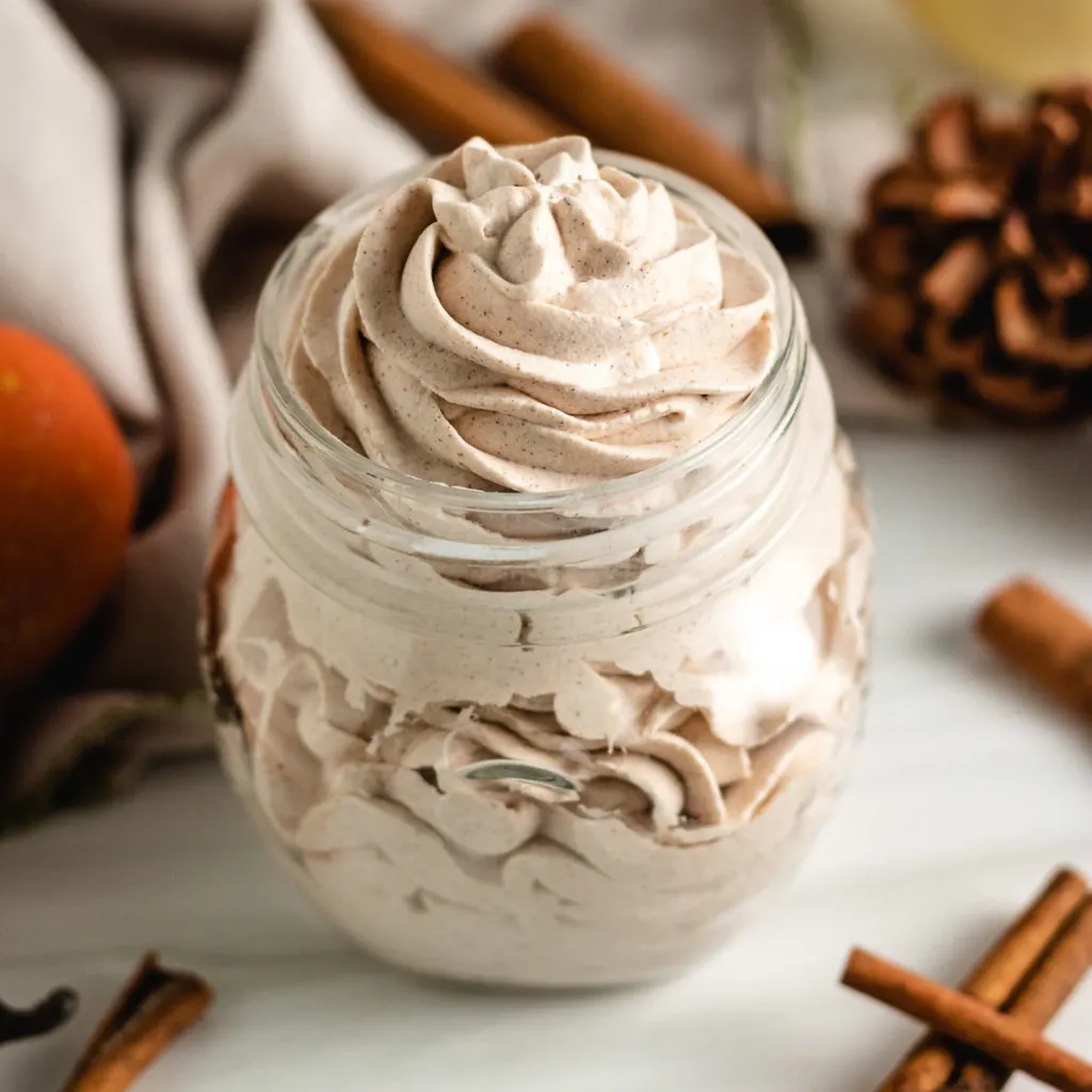Top down view of spiced whipped cream in a jar.
