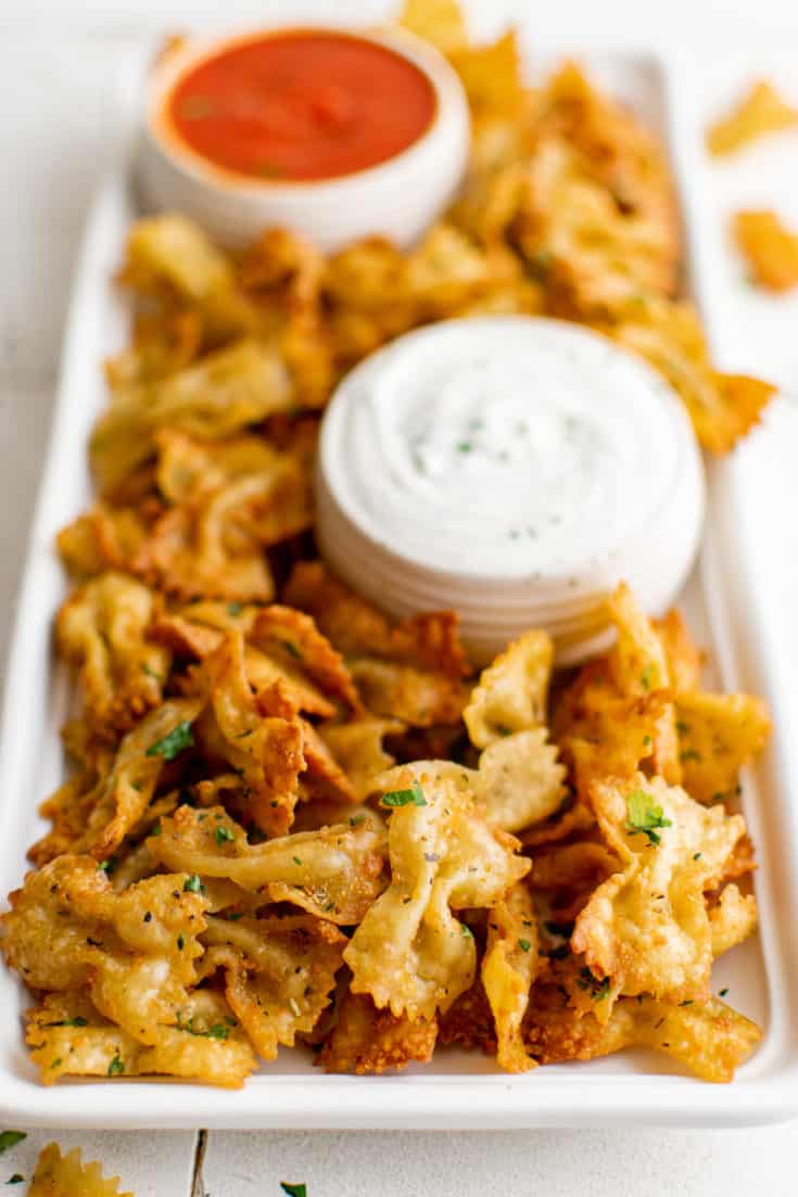 Large plate of pasta chips with ranch dressing.