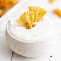 Bowl of ranch with two pasta chips.