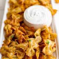 Platter of air fryer pasta chips with ranch dressing.