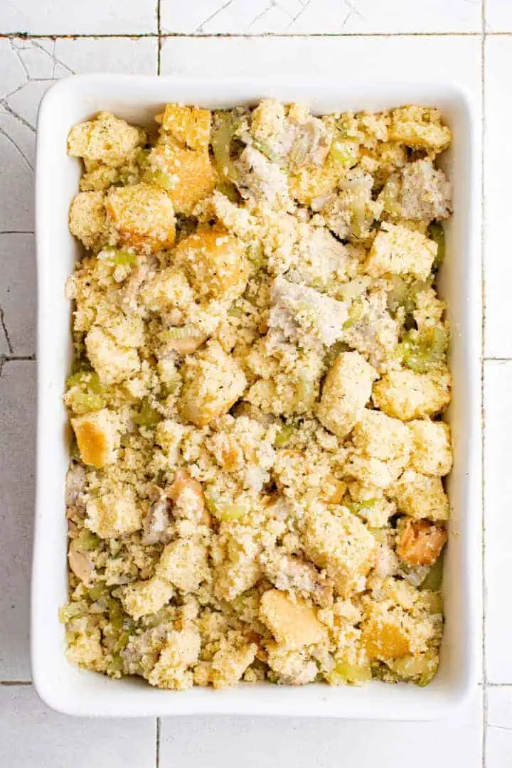 Southern Cornbread Dressing Recipe Unbaked cornbread stuffing in a pan.